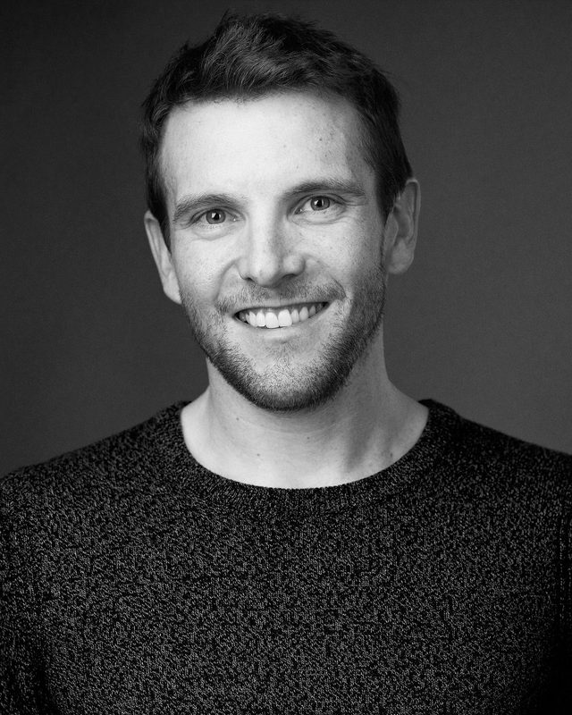 Black and white portrait of Brent Hocking smiling